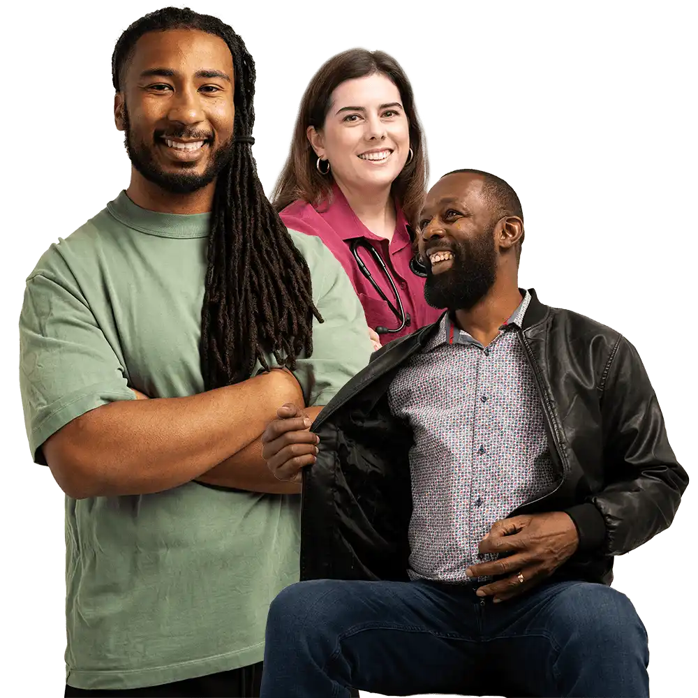 A group of three smiling people, including a doctor