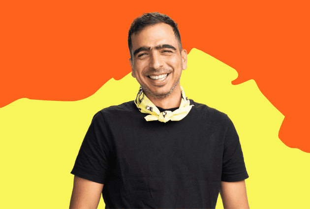 Man smiles at camera against an orange and yellow background