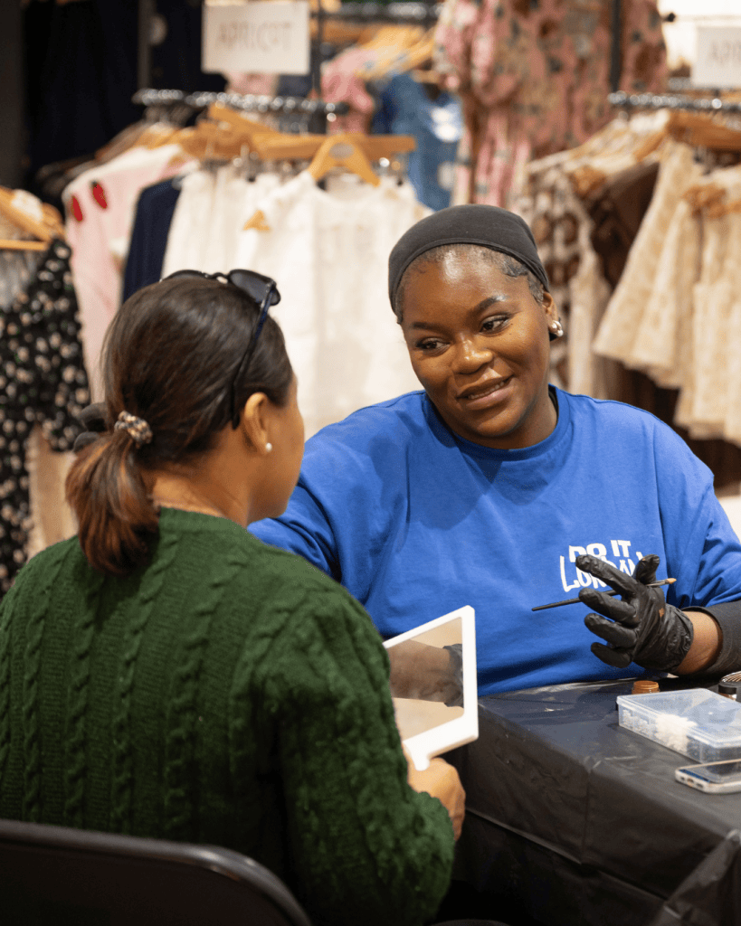 Florence, a member of the Glam Squad, speaks with a member of the public about health, beauty and the importance of HIV testing